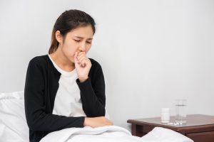 A woman is sicks and coughing to show pneumonia